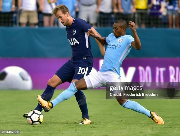 Fernandinho of Manchester City stretches to control the ball next to Harry Kane of Tottenham during the first half of the 2017 International...