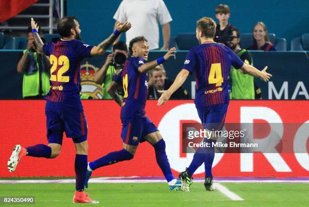 Ivan Rakitic of Barcelona celebrates his goal with teammates Neymar and Aleix Vidal in the first half against the Real Madrid during their...