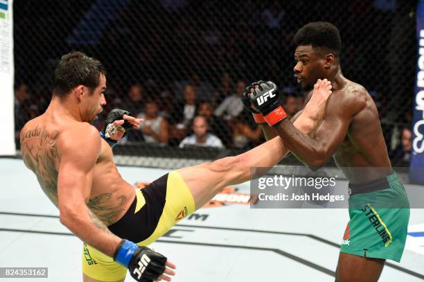 Renan Barao of Brazil kicks Aljamain Sterling in their 140-pound catchweight bout during the UFC 214 event at Honda Center on July 29, 2017 in...