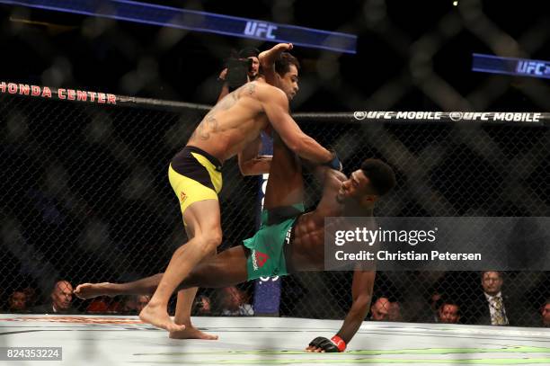 Aljamain Sterling slips after a kick against Renan Barao of Brazil in their 140-pound catchweight bout during the UFC 214 event at Honda Center on...