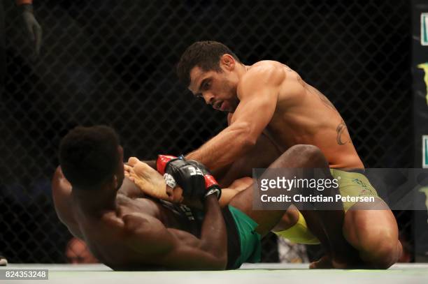 Aljamain Sterling controls the leg of Renan Barao of Brazil in their 140-pound catchweight bout during the UFC 214 event at Honda Center on July 29,...