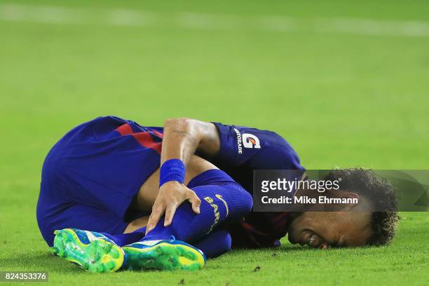 Neymar of Barcelona reacts to an injury in the second half against the Real Madrid during their International Champions Cup 2017 match at Hard Rock...