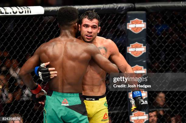 Aljamain Sterling and Renan Barao of Brazil embrace after their 140-pound catchweight bout during the UFC 214 event at Honda Center on July 29, 2017...