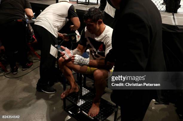 Renan Barao of Brazil sits outside the octogon after being defeated by Aljamain Sterling in their 140-pound catchweight bout during the UFC 214 event...