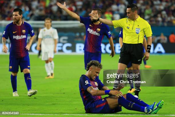 Neymar of Barcelona reacts to a foul in the first half against the Real Madrid during their International Champions Cup 2017 match at Hard Rock...