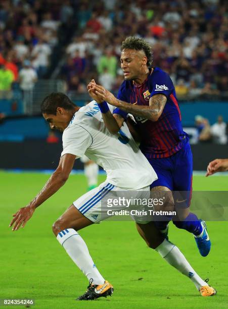 Neymar of Barcelona gets tripped up over Jesus Vallejo of Real Madrid in the first half during their International Champions Cup 2017 match at Hard...