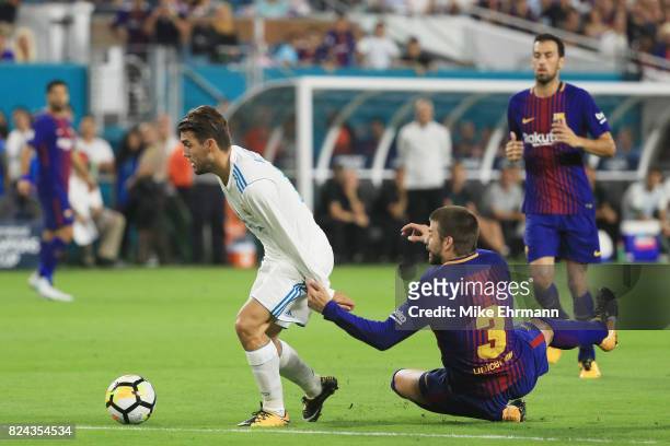 Mateo Kovacic of Real Madrid gets past Gerard Pique of Barcelona on his way to scoring a goal in the first half against the Barcelona during their...