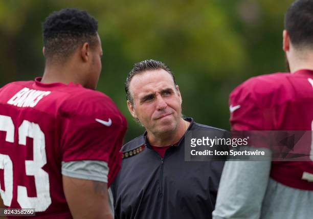 Washington Redskins defensive line coach Jim Tomsula chats with defensive lineman Brandon Banks and Matt Ioannidis during day three of Redskins...
