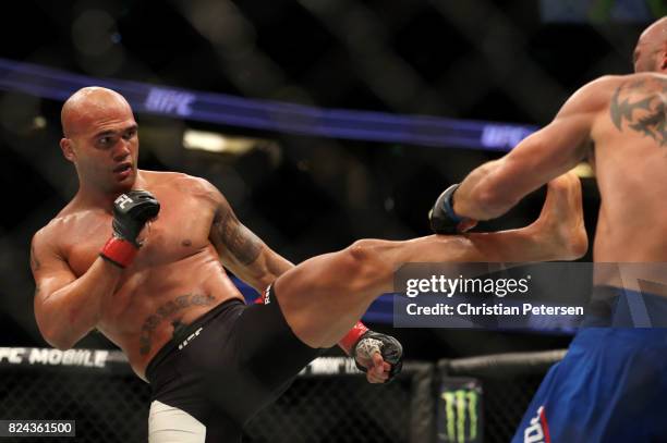 Robbie Lawler kicks Donald Cerrone in their welterweight bout during the UFC 214 event at Honda Center on July 29, 2017 in Anaheim, California.