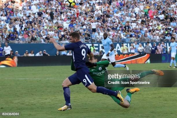 Manchester City goalkeepr Aro Muric punches the ball away from Tottenham Hotspur forward Vincent Janssen at the last second in the game between...