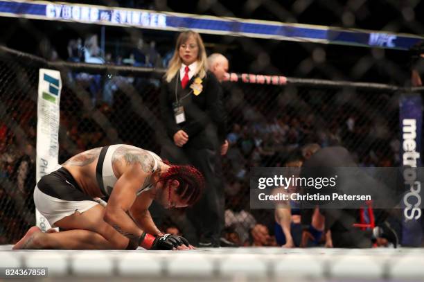 Cris Cyborg of Brazil reacts after defeating Tonya Evinger by TKO in their UFC women's featherweight championship bout during the UFC 214 event at...