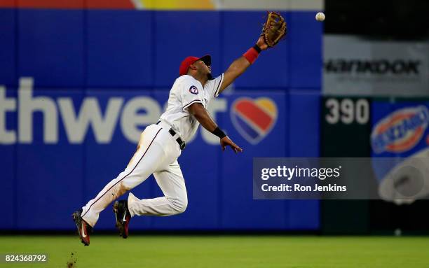 Elvis Andrus of the Texas Rangers can't get to single off the bat of Manny Machado of the Baltimore Orioles during the fourth inning at Globe Life...