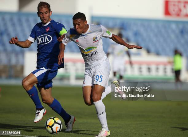 Real SC forward Vinicius from Brazil with CF Os Belenenses defender Goncalo Silva from Portugal in action during the League Cup match between CF Os...