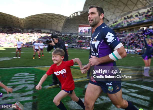 Cameron Smith of the Storm runs onto the ground as he plays his 350th match during the round 21 NRL match between the Melbourne Storm and the Manly...