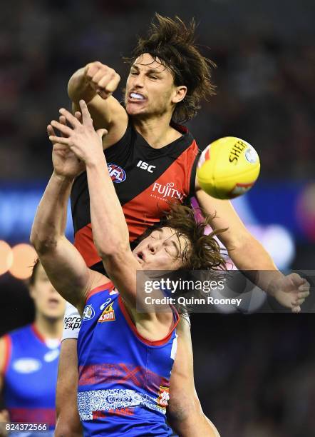 Mark Baguley of the Bombers spoils a mark by Liam Picken of the Bulldogs during the round 19 AFL match between the Western Bulldogs and the Essendon...