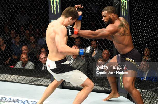 Tyron Woodley punches Demian Maia of Brazil in their UFC welterweight championship bout during the UFC 214 event at Honda Center on July 29, 2017 in...