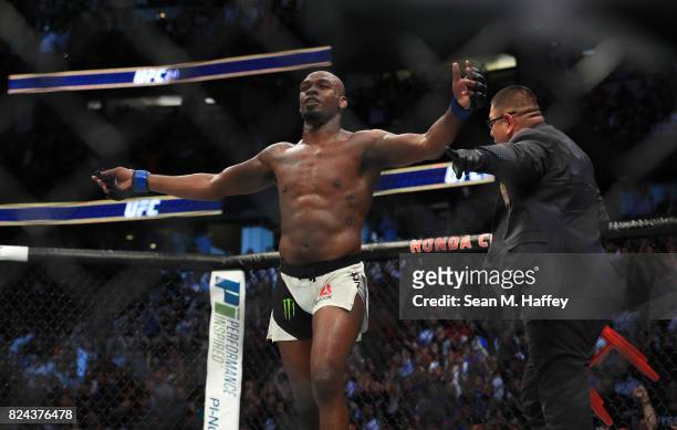 Jon Jones celebrates after knocking out Daniel Cormier in their UFC light heavyweight championship bout during the UFC 214 event at Honda Center on...