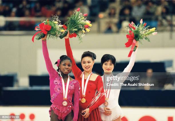 Silver medalist Surya Bonaly of France, gold medalist Chen Lu of China and bronze medalist Junko Yaginuma of Japan celebrate on the podium at the...