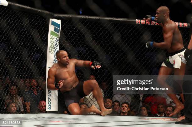 Daniel Cormier attempts to recover after receiving a kick from Jon Jones in their UFC light heavyweight championship bout during the UFC 214 event at...