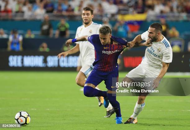 Neymar of Barcelona and Karim Benzema of Real Madrid vie for the ball during their International Champions Cup 2017 match at Hard Rock Stadium on...