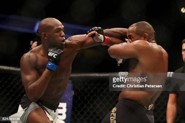 Jon Jones punches Daniel Cormier in their UFC light heavyweight championship bout during the UFC 214 event at Honda Center on July 29, 2017 in...