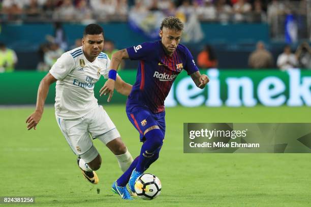 Casemiro of Real Madrid and Neymar of Barcelona vie for the ball during their International Champions Cup 2017 match at Hard Rock Stadium on July 29,...