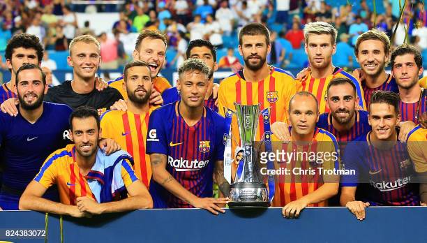 Barcelona celebrate with the trophy after defeating Real Madrid 3 to 2 in their International Champions Cup 2017 match at Hard Rock Stadium on July...