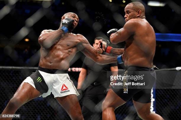 Jon Jones punches Daniel Cormier in their UFC light heavyweight championship bout during the UFC 214 event inside the Honda Center on July 29, 2017...