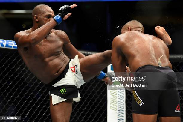 Jon Jones lands a kick to the head of Daniel Cormier in their UFC light heavyweight championship bout during the UFC 214 event inside the Honda...