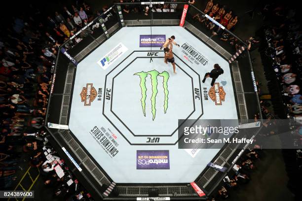An overhead view of the Octagon as Tyron Woodley punches Demian Maia of Brazil in their UFC Welterweight Championship bout during the UFC 214 event...