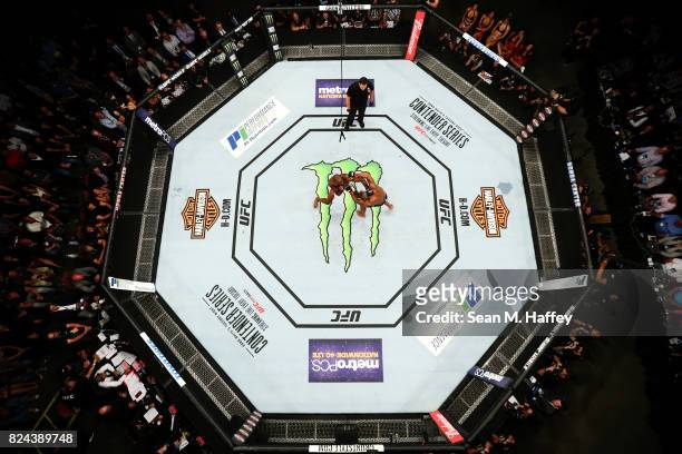 An overhead view of the Octagon as Jon Jones punches Daniel Cormier in their light heavyweight championship bout during the UFC 214 event at Honda...