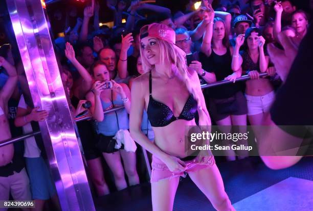 Mostly German-speaking visitors cheer as German singer Mia Julia, a former porn actress, takes off some of her clothes at the Oberbayern disco on the...
