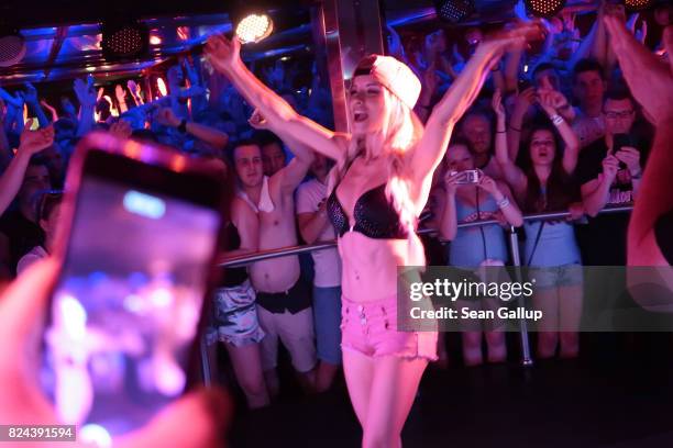 Mostly German-speaking visitors cheer to the performance of German singer Mia Julia, a former porn actress, at the Oberbayern disco on the Ballermann...