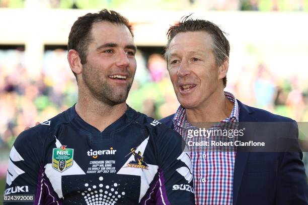 Cameron Smith of the Storm is acknowledged by coach Craig Bellamy after he played his 350th match during the round 21 NRL match between the Melbourne...