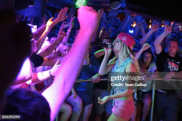 Mostly German-speaking visitors cheer to the performance of German singer Mia Julia, a former porn actress, at the Oberbayern disco on the Ballermann...
