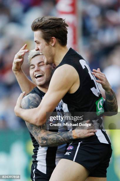 Darcy Moore of the Magpies celebrates a goal with Jamie Elliott during the round 19 AFL match between the Collingwood Magpies and the Adelaide Crows...