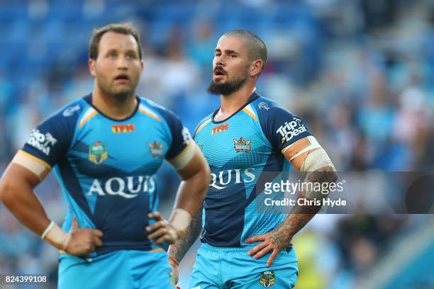 Tyrone Roberts and Nathan Peats of the Titans look on during the round 21 NRL match between the Gold Coast Titans and the Wests Tigers at Cbus Super...