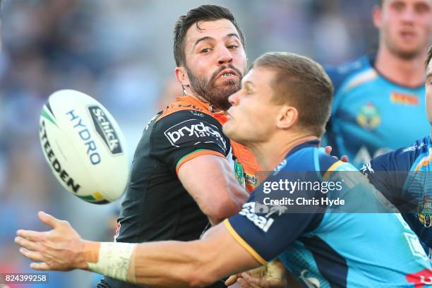 James Tedesco of the Tigers passes during the round 21 NRL match between the Gold Coast Titans and the Wests Tigers at Cbus Super Stadium on July 30,...