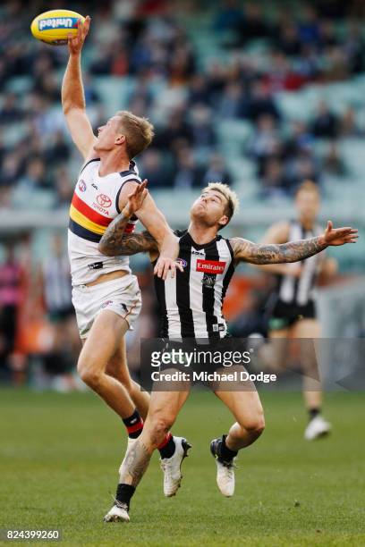 Alex Keath of the Crows and Jamie Elliott of the Magpies compete for the ball during the round 19 AFL match between the Collingwood Magpies and the...