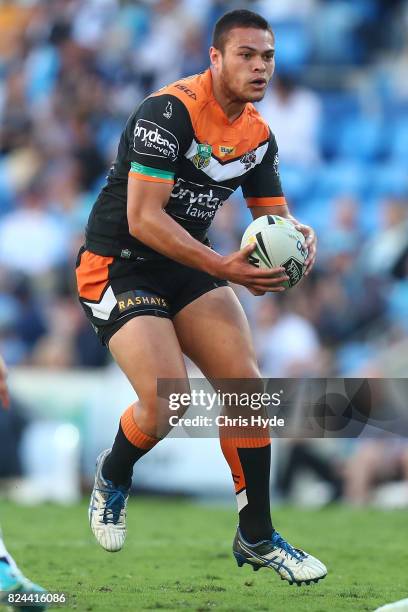 Tuimoala Lolohea of the Tigers runs the ball during the round 21 NRL match between the Gold Coast Titans and the Wests Tigers at Cbus Super Stadium...