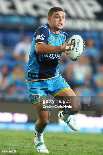 Ash Taylor of the Titans runs the ball during the round 21 NRL match between the Gold Coast Titans and the Wests Tigers at Cbus Super Stadium on July...