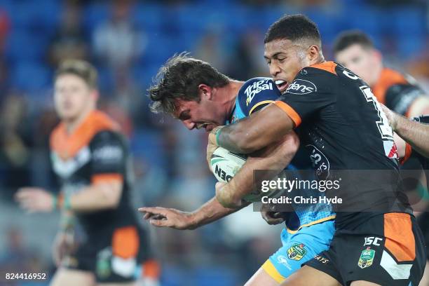 Joe Greenwood of the Titans runs the ball during the round 21 NRL match between the Gold Coast Titans and the Wests Tigers at Cbus Super Stadium on...