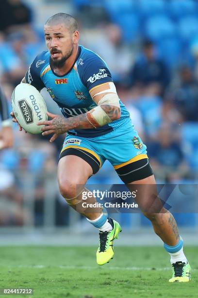 Nathan Peats of the Titans runs the ball during the round 21 NRL match between the Gold Coast Titans and the Wests Tigers at Cbus Super Stadium on...