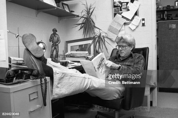 Arriving in his cinderblock studio at WGN-TV Phil Donahue bones up for his morning program with a book by the author who will be on his show, Nancy...