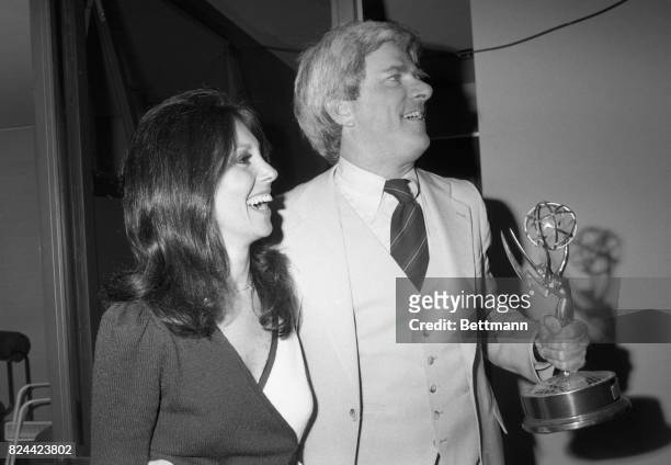 With actress Marlo Thomas at his side, Phil Donahue holds an Emmy he received in New York May 17 as the National Academy of Television Arts and...