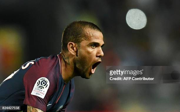 Paris Saint-Germain's Brazilian defender Dani Alves celebrates after scoring during the French Trophy of Champions football match between Monaco and...