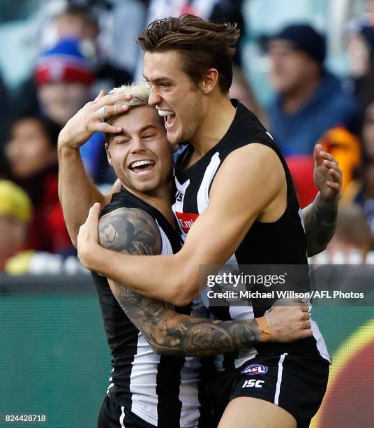 Jamie Elliott and Darcy Moore of the Magpies celebrate during the 2017 AFL round 19 match between the Collingwood Magpies and the Adelaide Crows at...