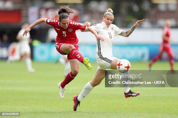 Simone Boye Sørensen of Denmark shoots while under pressure from Anja Mittag of Germany during the UEFA Women's Euro 2017 Quarter Final match between...