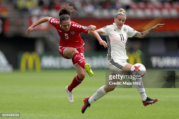 Simone Boye Sørensen of Denmark shoots while under pressure from Anja Mittag of Germany during the UEFA Women's Euro 2017 Quarter Final match between...