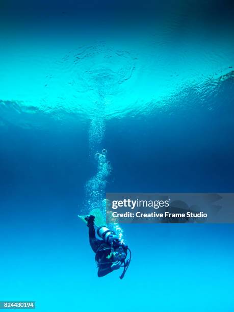 scuba diver decompressing during the immersion - deep stock-fotos und bilder